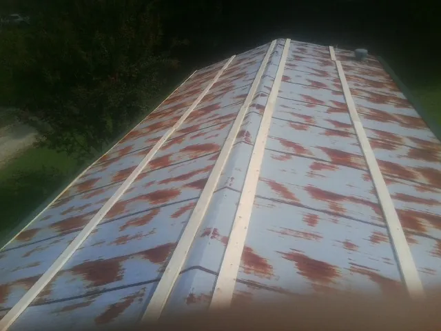 Rusted metal roof panels with new wood purlins before replacement — Storm Damage Roof Repair in New Albany by Roofing Brothers